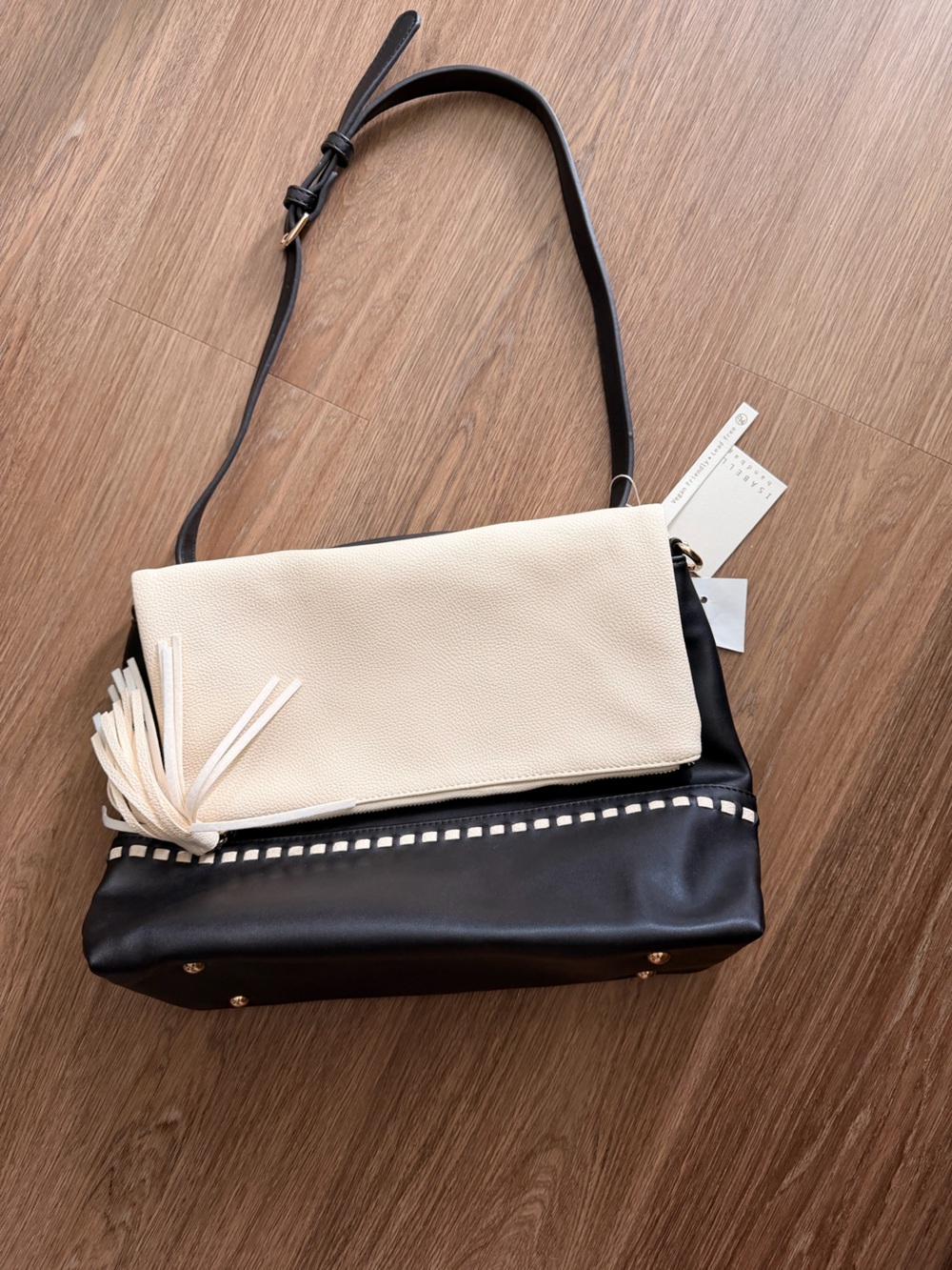 Two-Tone Black and Cream Shoulder Bag with Tassel Accent